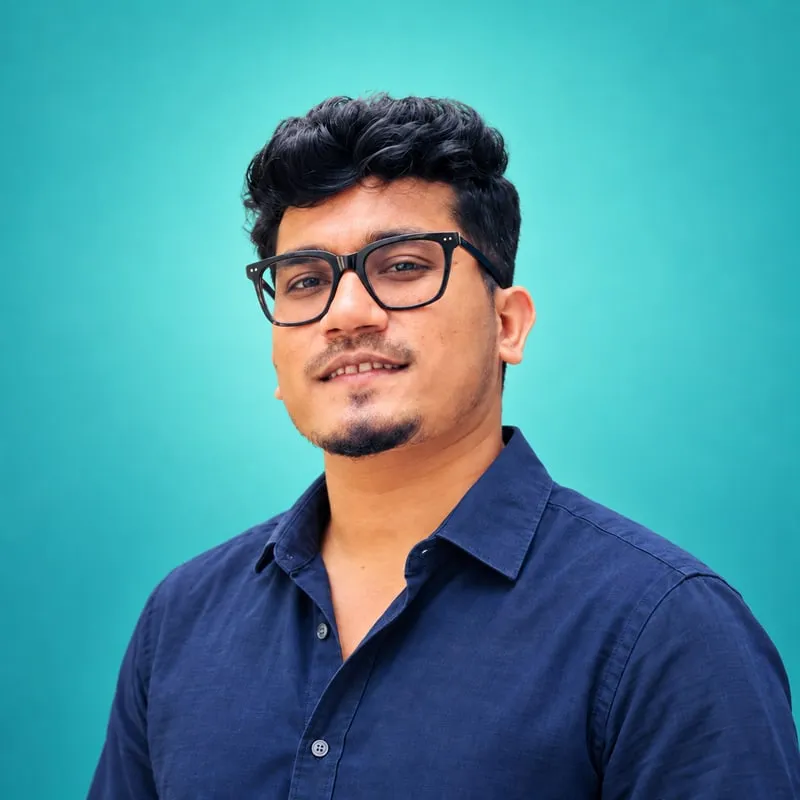 Shakawat Hridoy, smiling, in glasses and a navy shirt against a turquoise background