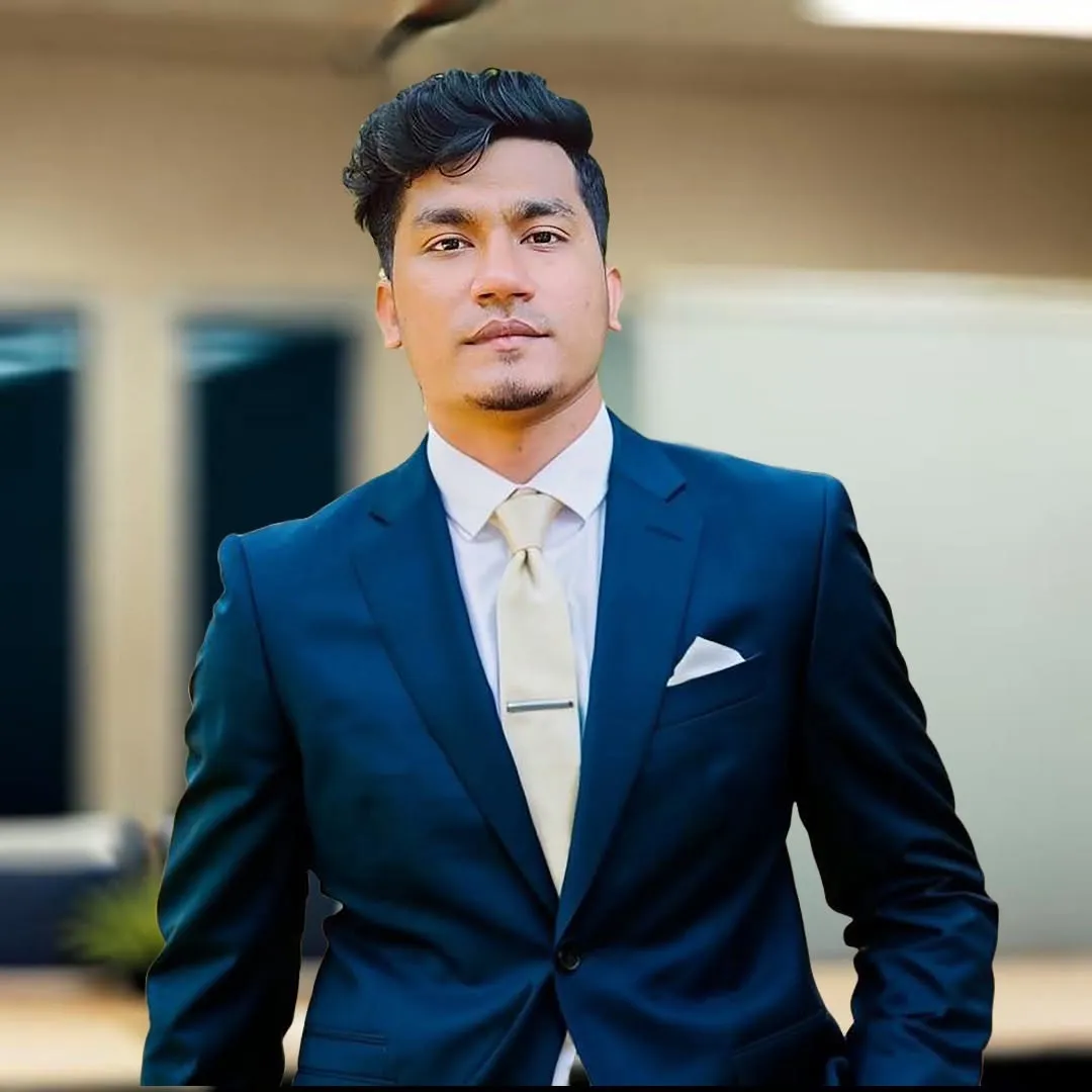 Shakawat Hridoy, web developer and AI automation specialist, in a navy suit with a cream tie and pocket square